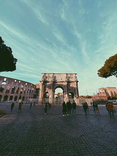 town people standing near The Colosseum building