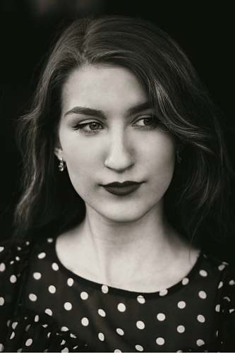 person woman in black and white polka-dot top face