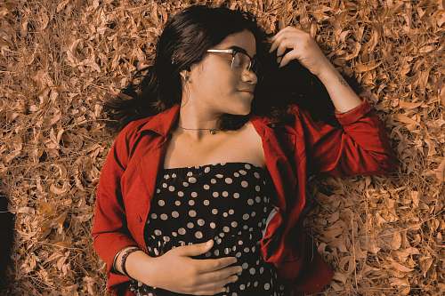 person woman lying on ground apparel