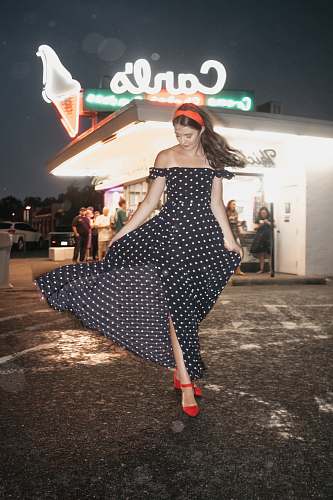person woman wearing polka-dot dress standing on ground fashion