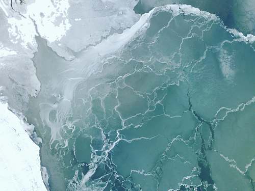 ice aerial photo of body of water outdoors