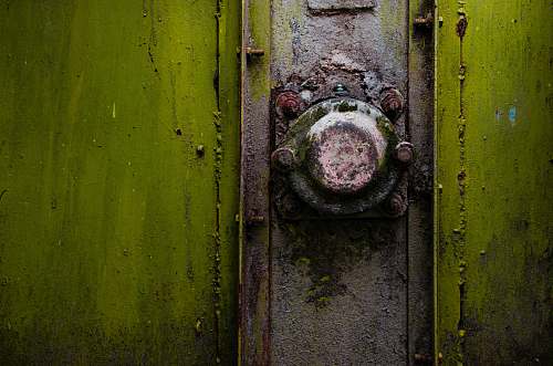 rust A close-up of a rusty metal knob on a green strongbox romania