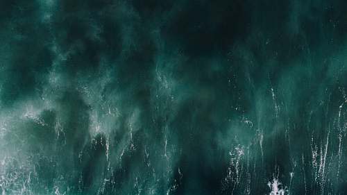 grey aerial photograph of green water ocean