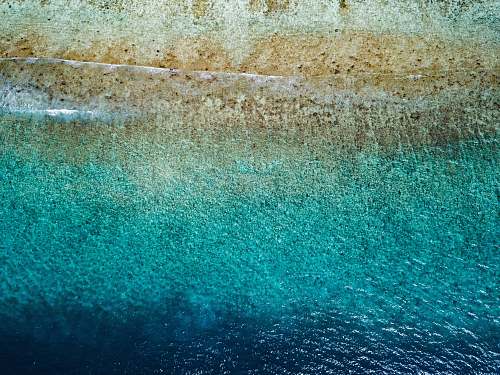 water aerial photography of shore blue