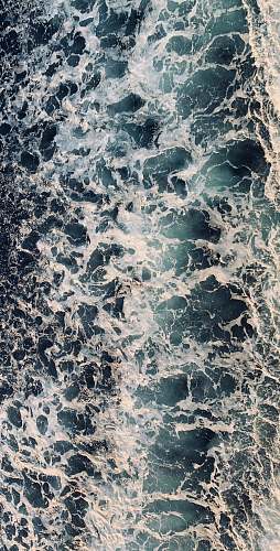 rug aerial view of sea waves during daytime rock