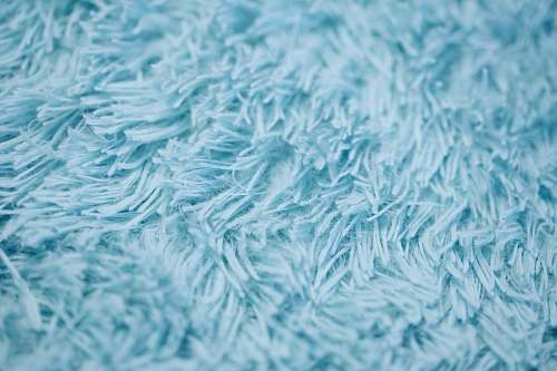 blue closeup photography of blue textile blanket