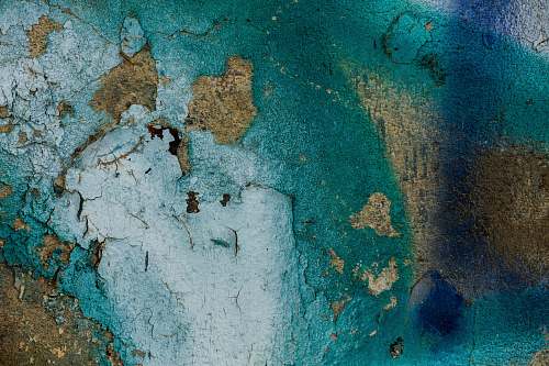 old concrete with sprayed blue, teal, and white paint painting