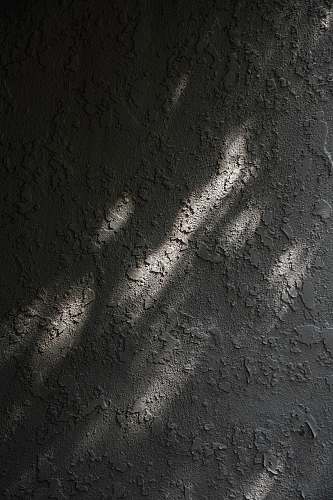 ground gray and white concrete wall asphalt