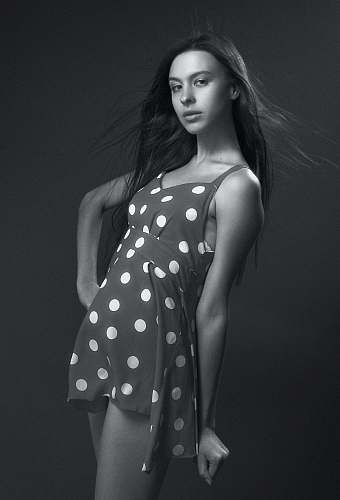 black-and-white grayscale photography of woman in polka-dot spaghetti strap mini dress human