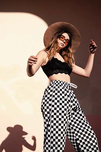human low angle photo of woman standing beside wall person