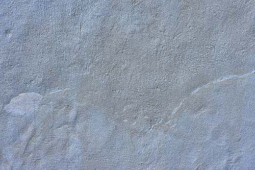grey person in black shoes standing on gray concrete floor concrete
