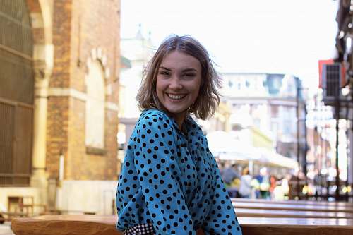 human smiling woman in blue and white polka dot robe person