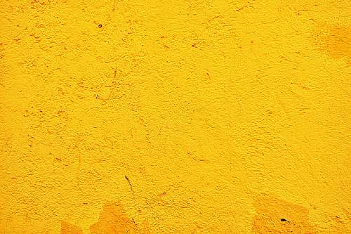 wall yellow concrete wall during daytime yellow