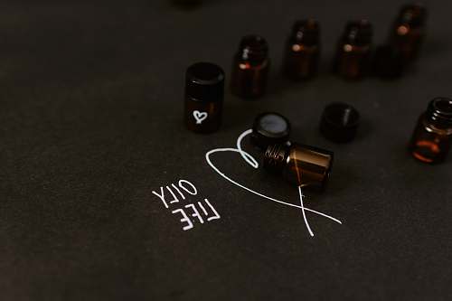 weaponry seven small bottle in black surface close-up photography weapon