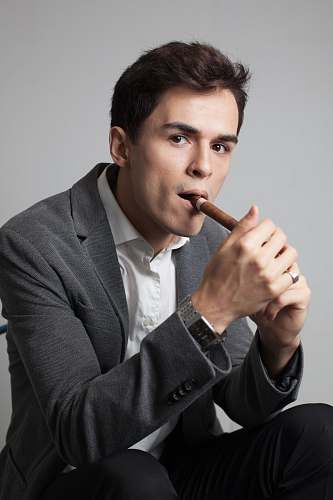 clothing man smoking cigar coat