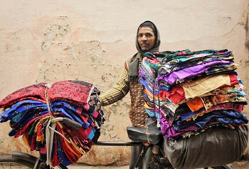 varanasi man standing beside bicycle with clothes india