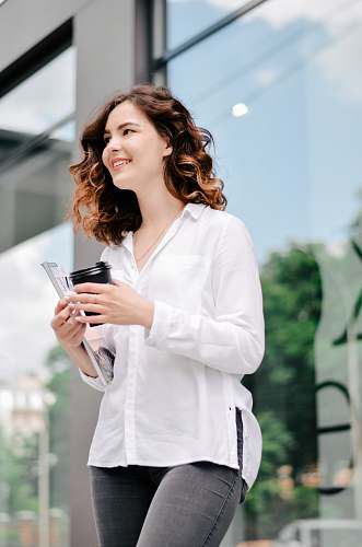 clothing woman holding tumbler lab coat