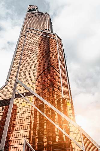 tower gold high-rise building under cloudy sky building