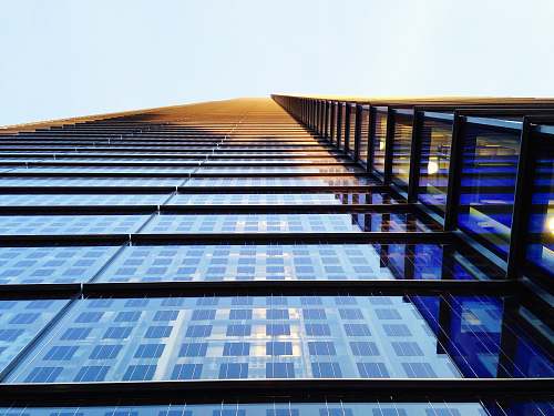 building low angle photography of building sun
