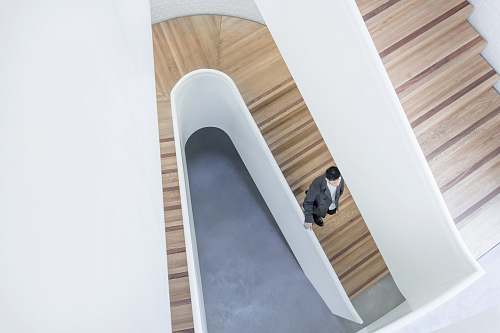 london person stepping down on brown wooden stairs aerial photography wood