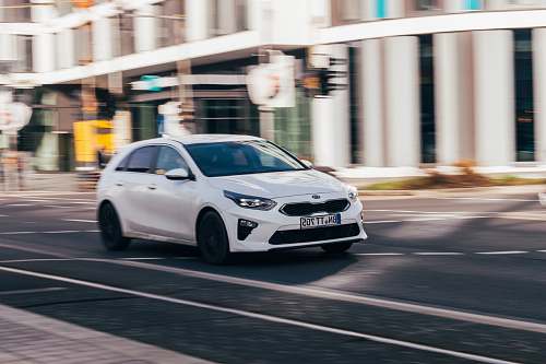transportation white sedan in road during daytime vehicle