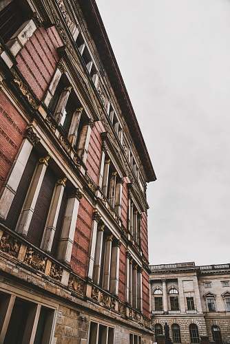 handrail brown and red building during daytime brick