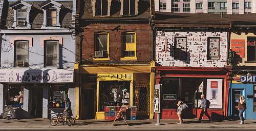 bike woman standing in front of red store during daytime toronto