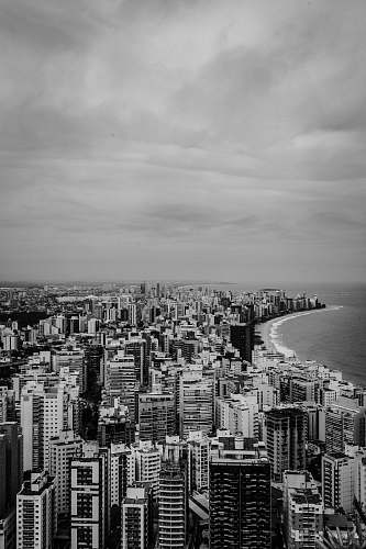 landscape building beside body of water in grayscale photo nature