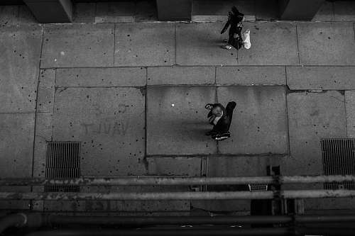 people grayscale photography of person walking on road grey