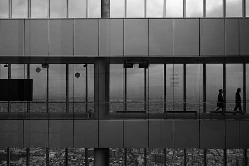 japan grayscale photography of two men inside building grey