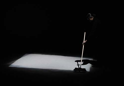 grey man holding rod la biennale di venezia arsenale