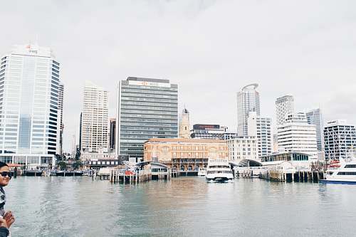 city white ship on body of water in front of building transportation