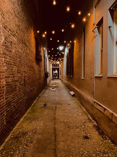 city alley with hanging lights during night corridor