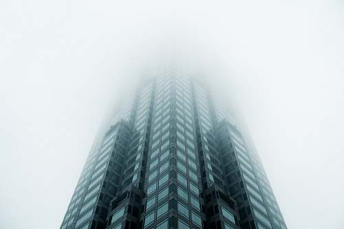 architecture black high-rise building covered with fog skyscraper