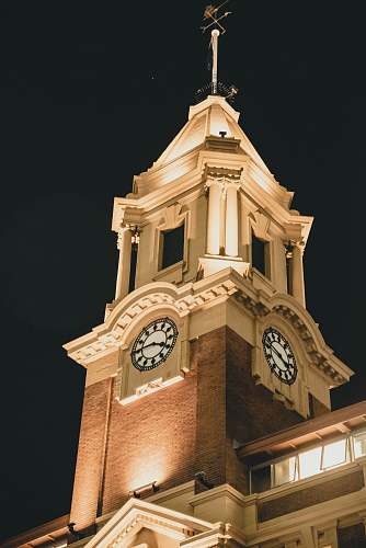 architecture brown concrete building clock tower