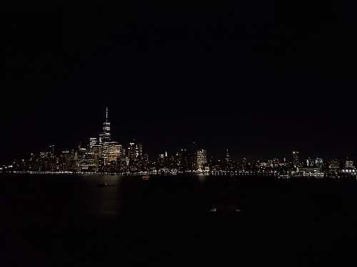 city buildings near ocean during nighttime metropolis