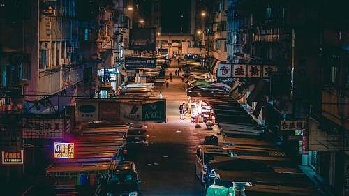 city cars parked near building during nighttime metropolis