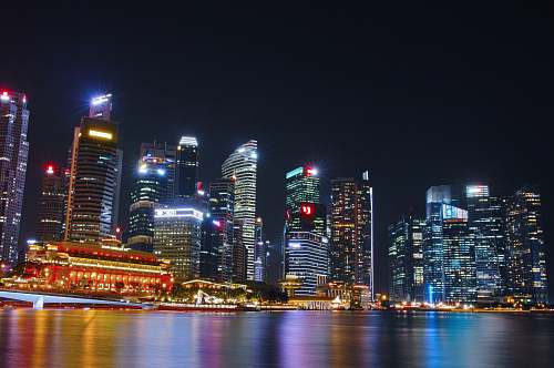 city city buildings near bodies of water at night time urban