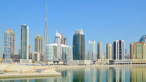 city city with high-rise buildings viewing blue body of water during daytime high rise