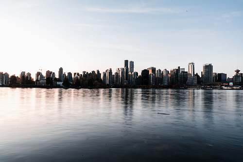 city cityscapes near body of water high rise