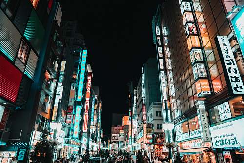 city crowd of people in the streets of a city during nighttime downtown