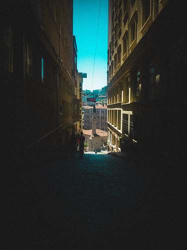 city dark walkway between buildings road