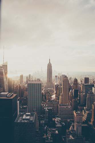 city Empire State Building under white sky high rise