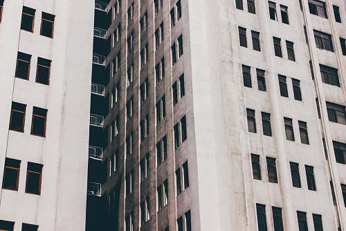city gray concrete building with windows urban