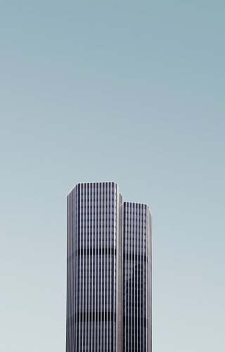 city grey and white high-rise building under white cloudy sky architecture