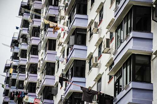 city hanged clothes on building terraces with poles during daytime home decor