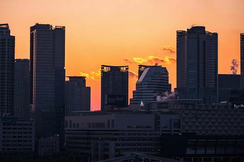 sunrise high rise buildings during sundown sunset