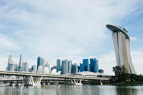city landscape photography of concrete structures near body of water urban