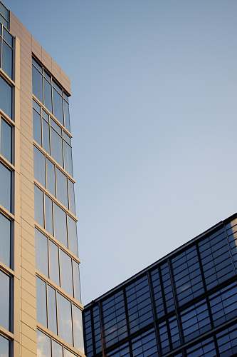 condo low angle photo of curtain glass wall building office building