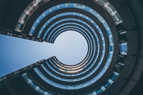 spiral low angle photography of architectural building blue